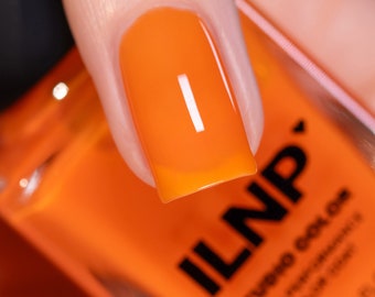 May include: A close-up of a bright orange nail polish bottle with the brand name "ILNP" printed on the label. The bottle is clear and shows the orange nail polish inside.