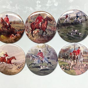 May include: Set of six round coasters featuring vintage equestrian hunting scenes. Each coaster depicts riders in red coats on horseback, accompanied by hounds, in various outdoor settings. A classic decorative item.