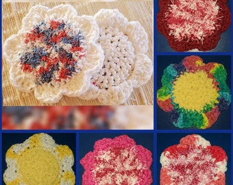May include: Six crocheted flower-shaped dishcloths in various colors, including white, red, blue, yellow, and green. The dishcloths are made with a textured yarn and have a fluffy appearance.