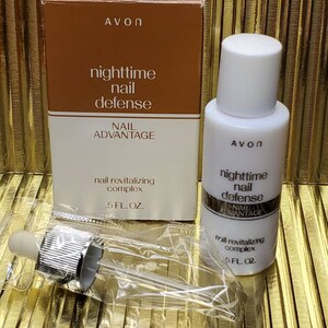 May include: A brown box with the text "NAIL ADVANTAGE nighttime nail defense nail revitalizing complex .5 FL. OZ. AVON" and a smaller bottle with the text "AVON nighttime nail defense NAIL ADVANTAGE nail revitalizing complex .5 FL. OZ."