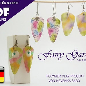 May include: A pair of colourful polymer clay earrings with a fairy garden theme. The earrings are shaped like teardrops and have a translucent, watercolour-like finish. The earrings are labelled "Fairy Garden Ohrringe" and "Polymer Clay Projekt von Nevenka Sabo".