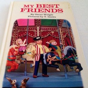 May include: A vintage children's book titled "My Best Friends" by Oscar Weigle, with illustrations by T. Izawa. The cover features a carousel scene with figurines of children and horses. The carousel has red curtains and a blue base.