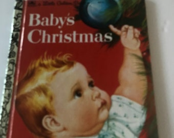 May include: A vintage children's book titled "Baby's Christmas" with a red cover. The cover features an illustration of a baby reaching for a Christmas ornament. The book has a gold spine.