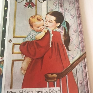 May include: Illustration from a children's book depicting a young girl in a red dress holding a baby. The text reads, "What did Santa leave for Baby? Let's go in and see." The scene is set near a door and staircase.