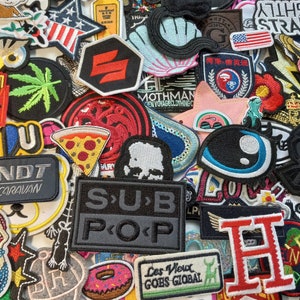 May include: A collection of colourful embroidered patches featuring various designs, including a pizza slice, a donut, a fish, a seashell, a palm tree, a black cat, a marijuana leaf, a red and white striped star, a red and white striped heart, a red and white striped flag, a red and white striped letter H, a red and white striped letter U, a red and white striped letter N, a red and white striped letter D, a red and white striped letter T, a red and white striped letter C, a red and white striped letter A, a red and white striped letter R, a red and white striped letter V, a red and white striped letter A, a red and white striped letter N, a red and white striped letter S, a red and white striped letter P, a red and white striped letter O, a red and white striped letter P, a red and white striped letter S, a red and white striped letter U, a red and white striped letter B, a red and white striped letter P, a red and white striped letter O, a red and white striped letter P, a red and white striped letter L, a red and white striped letter E, a red and white striped letter S, a red and white striped letter V, a red and white striped letter I, a red and white striped letter E, a red and white striped letter U, a red and white striped letter X, a red and white striped letter G, a red and white striped letter O, a red and white striped letter E, a red and white striped letter S, a red and white striped letter G, a red and white striped letter I, a red and white striped letter O, a red and white striped letter B, a red and white striped letter A, a red and white striped letter L, a red and white striped letter W, a red and white striped letter L, a red and white striped letter F, a red and white striped letter T, a red and white striped letter O, a red and white striped letter G, a red and white striped letter E, a red and white striped letter T, a red and white striped letter H, a red and white striped letter E, a red and white striped letter R, a red and white striped letter E, a red and white striped letter  and a red and white striped letter  .