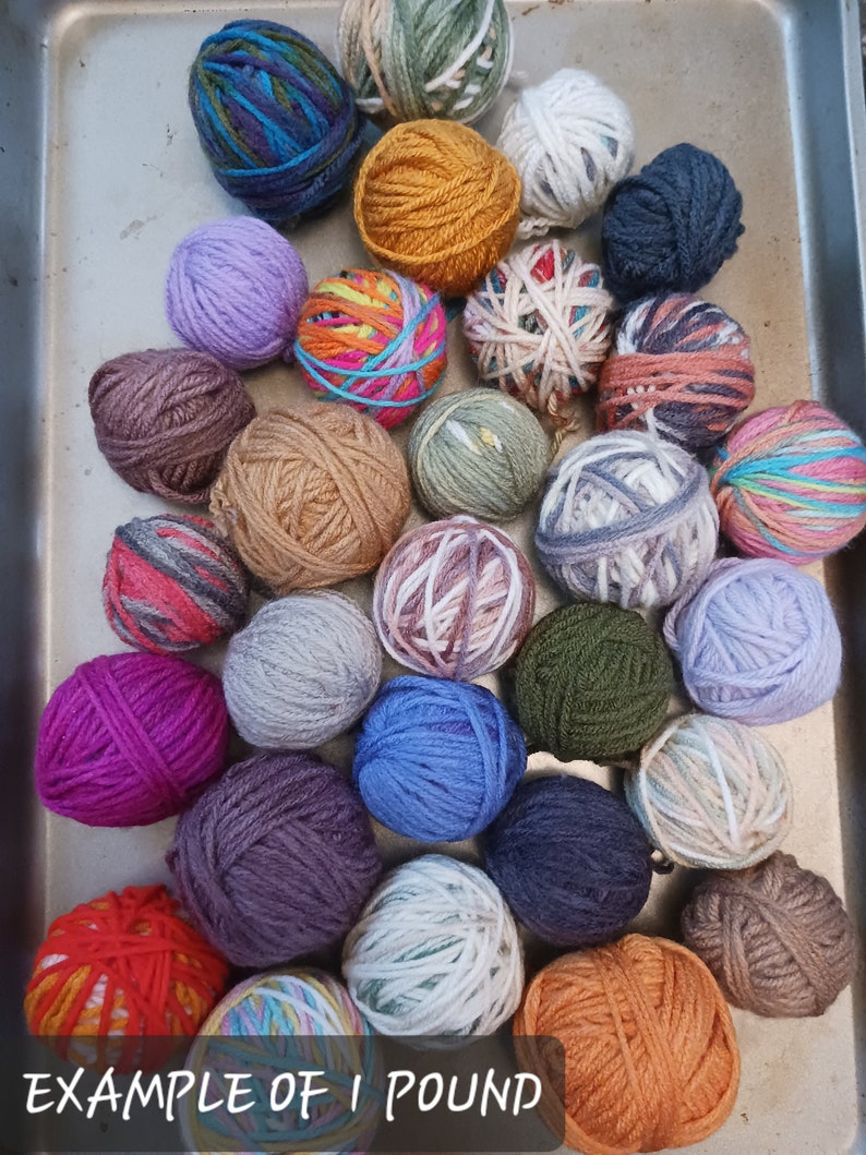 May include: A collection of colorful yarn balls in various shades of blue, purple, green, orange, and brown. The text "EXAMPLE OF 1 POUND" is at the bottom. These yarn balls are ideal for knitting and crocheting projects.