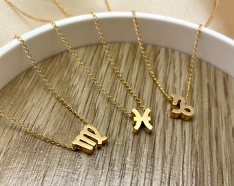 May include: Four gold necklaces with zodiac signs as pendants. The signs are Virgo, Pisces, and Capricorn.