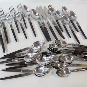 May include: A set of stainless steel silverware with brown wooden handles. The set includes forks, knives, and spoons.
