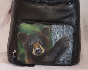 REDUCED Leather Top Flat Zippered Backpack with a hand painted portrait Shenan, a black bear cub.