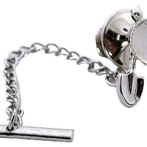 May include: A silver-toned tie tack featuring a miniature construction-themed design. The design includes a cement mixer, shovel, and anchor, connected by a chain to a bar-shaped clasp. The tie tack is likely made of metal.