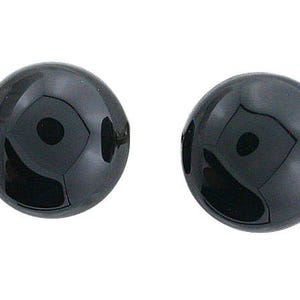 May include: Two round, glossy black earrings. The earrings are smooth and reflect light, creating a shiny appearance. The simple design makes them versatile for various outfits and occasions.