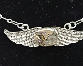 Steampunk style wing pendant with watch movement
