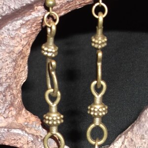 Steampunk style dangle earrings with brass ornate hook and gear