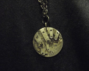 Steampunk style brass tone chain necklace with watch movement pendant
