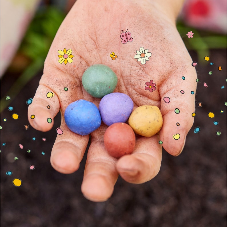 May include: A hand holding six colorful Easter eggs, decorated with small flower and butterfly designs.