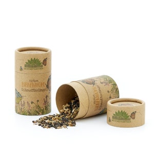 May include: Three brown cardboard tubes with a floral design and the text "Aktion Bienenwohl Schmetterlingswiesen" and "Die Stadtg&auml;rtner". The tubes contain wildflower seeds.