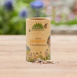 May include: A brown cardboard tube with a green and yellow butterfly design. The tube is labeled "Aktion Bienenwohl Schmetterlinge!" and "Die Stadtg&auml;rtner".