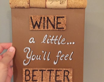 Sign made with recycled corks - "WINE a little... You'll feel BETTER"