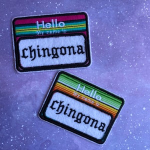 May include: Two colorful embroidered iron-on patches with the text "Hello My name is chingona" in a gothic font.