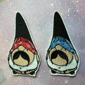 May include: Two embroidered gnome patches. One gnome wears a red bandana, the other a blue bandana. Both have black hats, large mustaches, and white shirts. The patches are outlined in white.