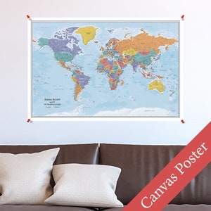 May include: A world map poster printed on canvas with a light blue background. The map is in color and shows the continents and oceans. The poster is hanging on a wall above a brown leather couch with two white pillows.