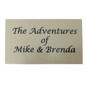 May include: A beige plaque with black text that reads "The Adventures of Mike & Brenda".