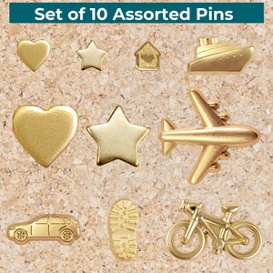 May include: Set of 10 assorted gold-colored pins in various shapes, including hearts, stars, a house, a ship, an airplane, a car, a footprint, and a bicycle. The text "Set of 10 Assorted Pins" is at the top.