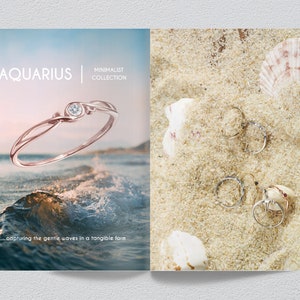 May include: A rose gold ring with a small diamond set in a wave-like design. The ring is photographed against a blue ocean background with a wave cresting in the foreground. The text "AQUARIUS | MINIMALIST COLLECTION" is displayed above the ring. The text "...capturing the gentle waves in a tangible form" is displayed below the ring.