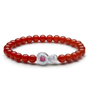 May include: A red carnelian beaded bracelet with a silver charm featuring a pink gemstone.