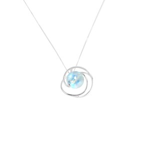 May include: A silver necklace with a delicate, swirling design that holds a light blue gemstone.