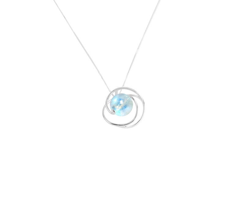 May include: A silver necklace with a delicate, swirling design that holds a light blue gemstone.