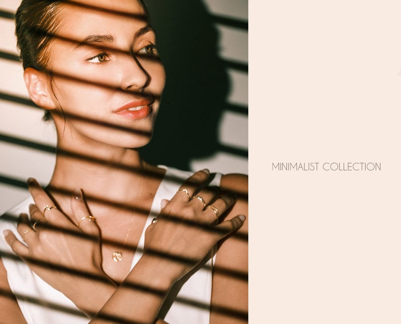 May include: A woman wearing a white shirt and gold rings. The image is in a minimalist style with the text "MINIMALIST COLLECTION" in the background.