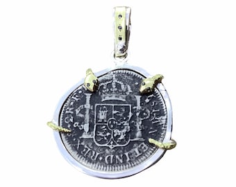 Coin bezel in sterling silver with black stones.