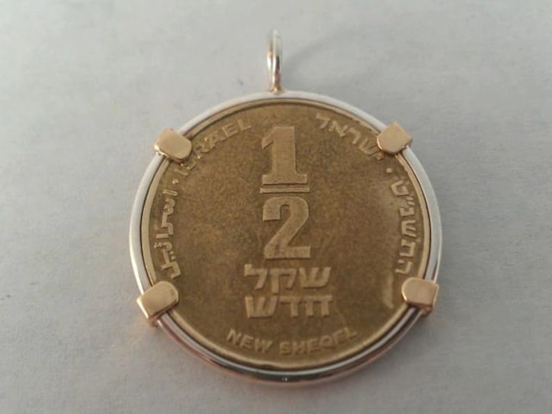 Personalized Coin Bezel Silver coin bezel with brass prongs.