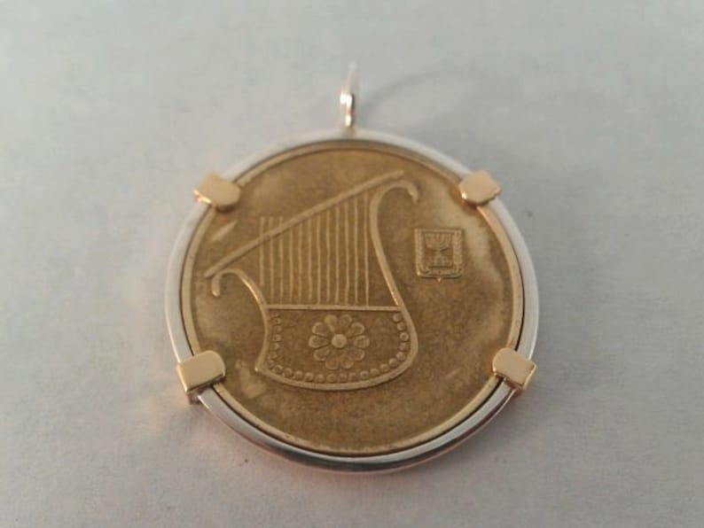 Personalized Coin Bezel Silver coin bezel with brass prongs.