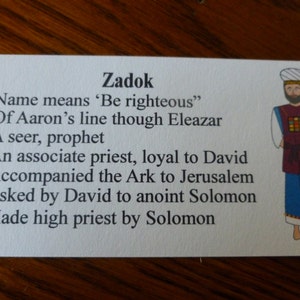 May include: A white card with black text about Zadok, a biblical figure. The text explains that Zadok was a seer, prophet, and associate priest who was loyal to David. The card also includes an illustration of Zadok wearing a colorful robe.
