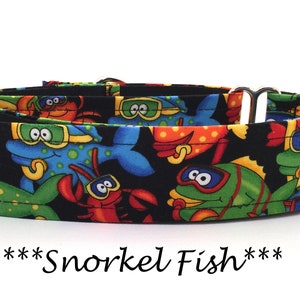 May include: A black and white dog collar with a colorful print of fish wearing goggles and crabs. The text "***Snorkel Fish***" is printed below the collar.