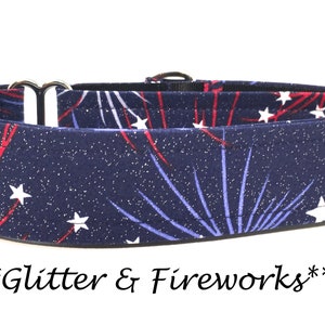 May include: A blue, red, and white patterned dog collar with silver hardware. The pattern features fireworks and stars on a navy blue background with glitter. The text "***Glitter & Fireworks***" is printed below the collar.