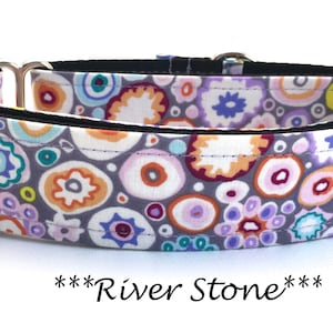 May include: A purple, gray, orange, pink, and blue patterned dog collar with silver hardware. The collar has the text "***River Stone***" printed on it.