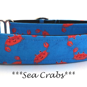May include: A blue dog collar with a pattern of red crabs and the text "***Sea Crabs***".