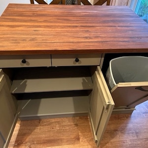 Custom kitchen island with overhang for seating. Kitchen cabinet storage. Trash bin. Handcrafted furniture. Made in USA. Made to order and custom built kitchen island. Heirloom quality furniture