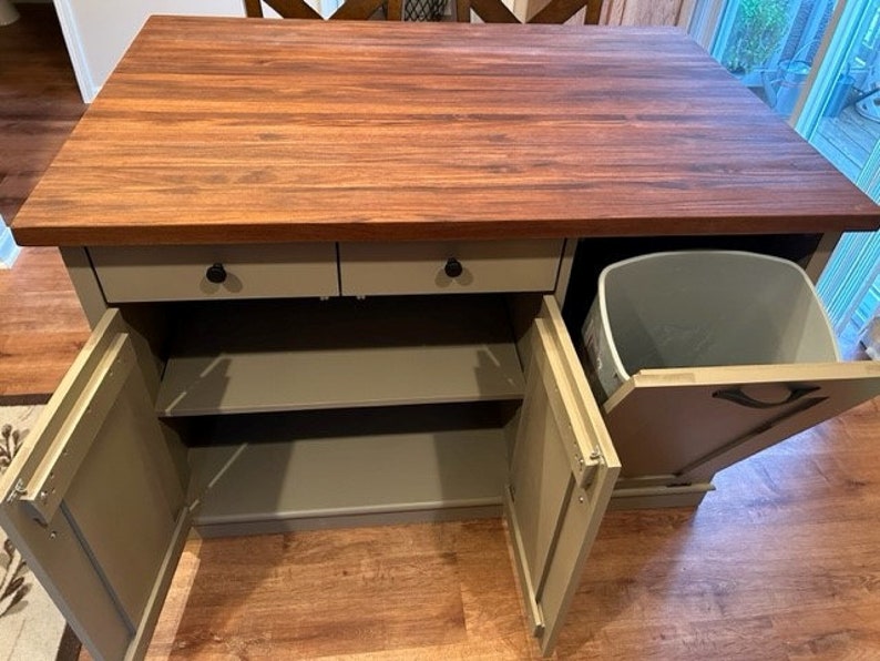 Custom kitchen island with overhang for seating. Kitchen cabinet storage. Trash bin. Handcrafted furniture. Made in USA. Made to order and custom built kitchen island. Heirloom quality furniture