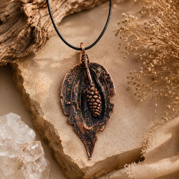 Actual real leaves coated in copper through electroforming — each pendant is a literal preserved leaf, making every single one genuinely one-of-a-kind botanical art.