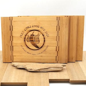 May include: Set of four wooden cutting boards with a laser-engraved design. The design features a chili pepper and the text "Flex Chili Cook Off 2024 1st Place Best Chili and Decorations".