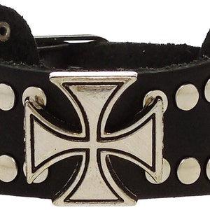 May include: Black leather bracelet with silver studs and a large silver cross buckle.