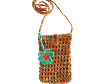 May include: A small crocheted crossbody bag with a green and orange pattern. The bag has a single button closure and a small crocheted flower attached to the front.
