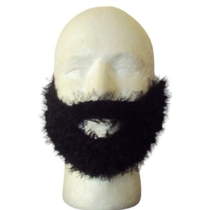 May include: A black, faux beard attached to a white mannequin head. The beard is made of a fuzzy material and is designed to fit around the chin and mouth area. The background is plain white.