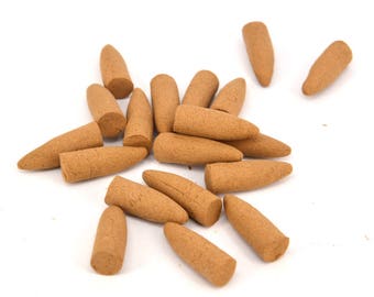 May include: A pile of brown incense cones on a white background. The cones are approximately 5 cm long and have a pointed tip.