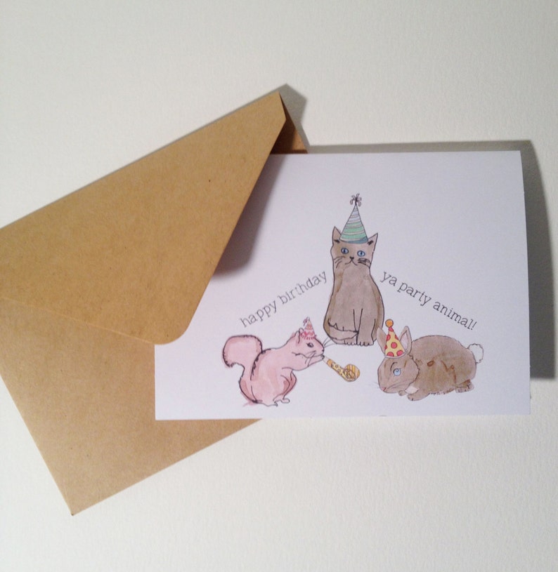 May include: A birthday card with a cat, squirrel, and rabbit wearing party hats. The card says "happy birthday ya party animal!"