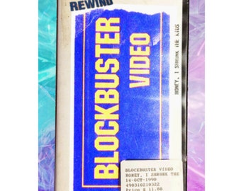 May include: A blue and yellow Blockbuster Video VHS tape case with a sticker that says "BE KIND PLEASE REWIND". The case has a barcode and the title "HONEY, I SHRUNK THE KIDS".